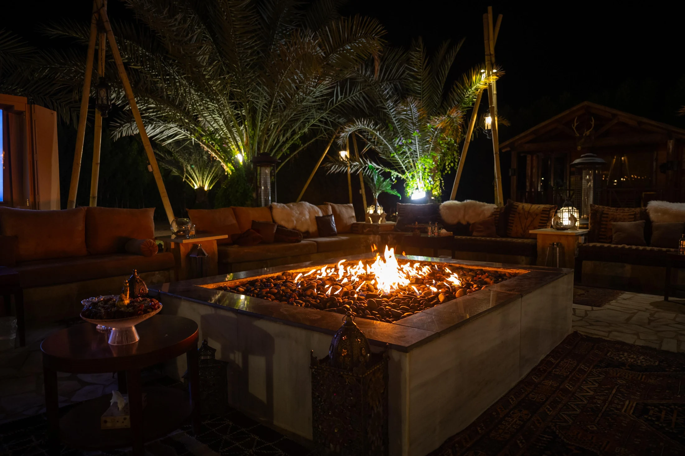 The illuminated fire courtyard at Nibras after dark